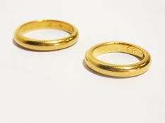 Graduated pair of 22ct gold wedding rings inscribed with initials and date on the inside, 17.