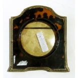 Early 20th century silver and tortoiseshell photograph frame of shaped form,
