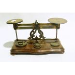 Pair of postage scales with weights, a b