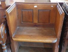 A church seat with carved gothic sides