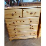 A pine chest of drawers with four drawer