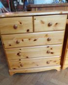 A pine chest of drawers with four drawer