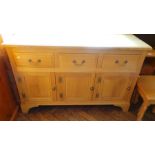 An oak sideboard with three short drawer