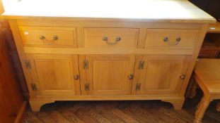An oak sideboard with three short drawer
