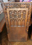 An oak church pew with gothic floral car