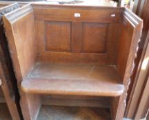 A church seat with carved gothic sides