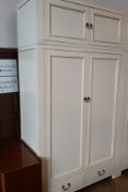 A cream painted hardwood double wardrobe