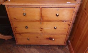 A pine chest of drawers with two short d