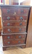 A stained wood and glazed corner cabinet