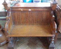 An oak church seat with carved roundel