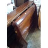 Stained wood sleigh bed with fitted bed
