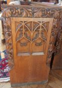 An oak church pew with gothic floral car