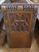 An oak church pew with gothic floral car