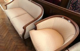 An Edwardian walnut winged tub chair with cream floral cover and an Edwardian walnut winged sofa