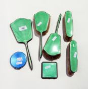 Green enamel backed dressing table set comprising pair of hairbrushes, two clothes brushes,
