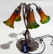 A Tiffany style lamp on intertwined necks,