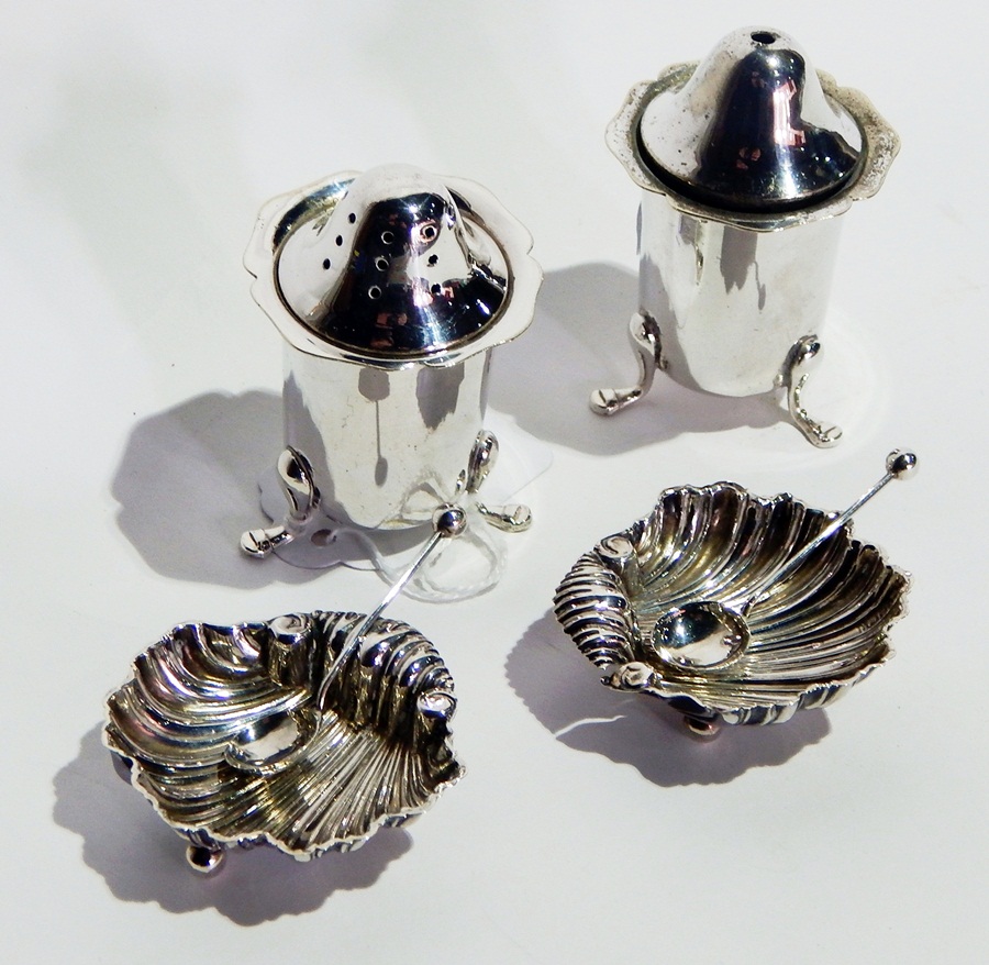 A pair of silver scallopshell salts with spoons and a pair of silver-plated salt and pepperpots (4)