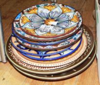 A quantity of studio plates and continental style pottery plates (11)