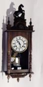 A Vienna regulator style wall clock on bulbous and turned supports,