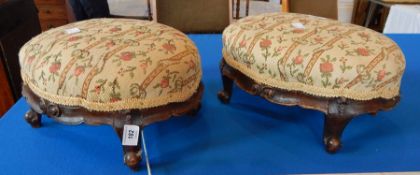 A pair of Victorian footstools with upholstered needlework oval tops,