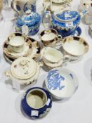 Early 19th century blue and white pottery Willow pattern teapot and stand with gilt highlights,