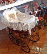 Reproduction Victorian style pram with decorative fabric lining and a bisque head Hanah collector's