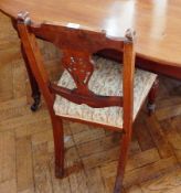 A set of six Victorian rosewood dining chairs with foliate carved splats,