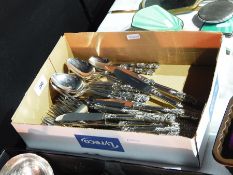 A quantity of silver plate flatware to include dinner knives and forks, dessert spoons, etc.