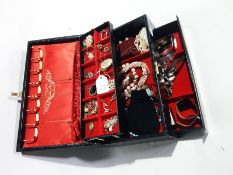 A jewellery case with hinged stepped fitted interior enclosing a quantity of costume jewellery to