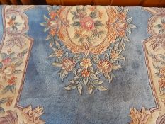 Chinese wool rug, pale blue ground with cream central motif and shaped borders,