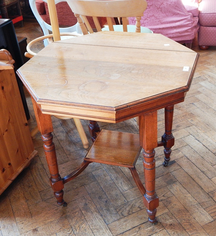 A Victorian octagonal side table on block and fluted supports and brass castors