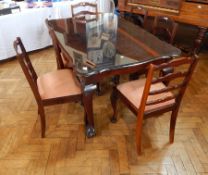 A rosewood Georgian style rectangular top dining table with plate glass top, wavy moulded edge,