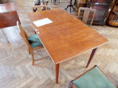 A modern hardwood extending dining table with moulded edge, on square tapering legs,