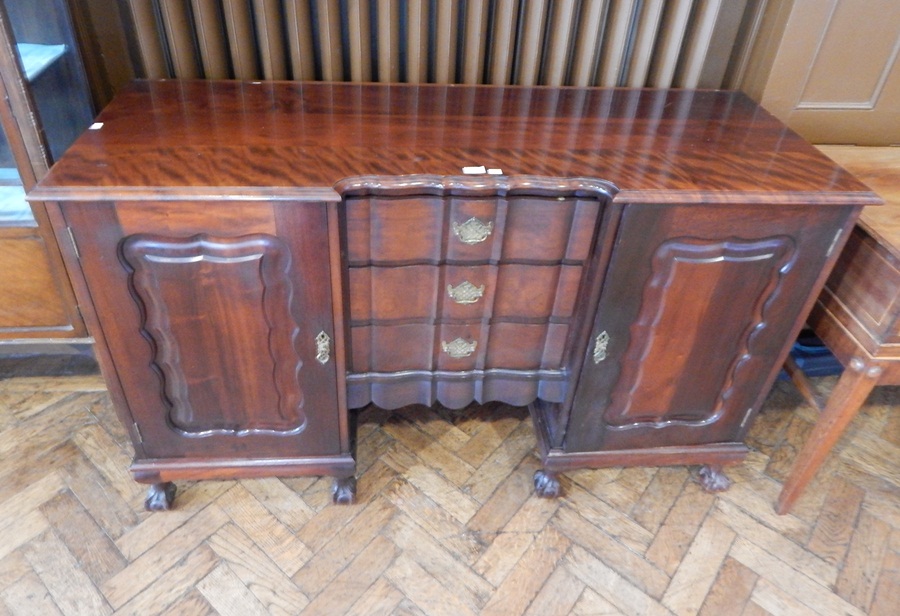 Reproduction Chippendale style mahogany sideboard the pair of panelled doors enclosing shelves,