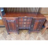 Reproduction Chippendale style mahogany sideboard the pair of panelled doors enclosing shelves,