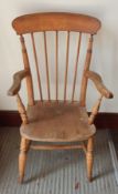 A Windsor hardwood armchair with stick back supports on tapering legs