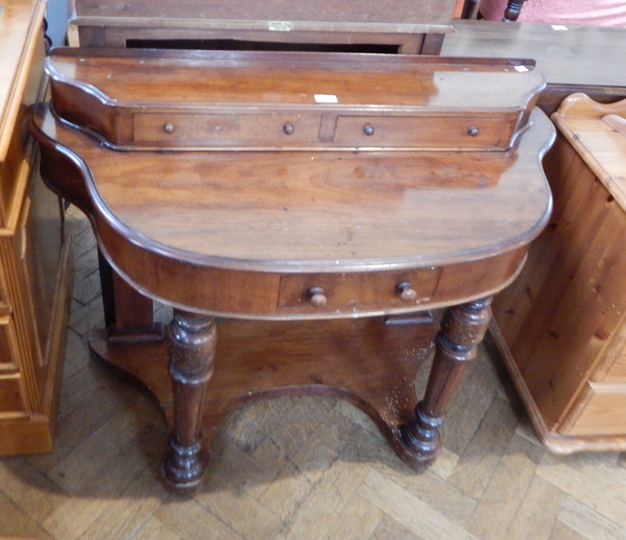 A Victorian mahogany dressing table with two short drawers on top and one short drawer in the