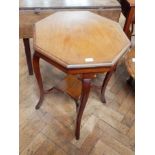 An Edwardian walnut octagonal top occasional table with square cabriole legs united by cross