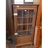 Continental style walnut display cabinet having rectangular glazed panel doors,