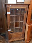 Continental style walnut display cabinet having rectangular glazed panel doors,
