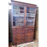 A Victorian mahogany library bookcase with two sets of five graduating drawers,