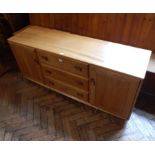 Ercol elm sideboard having three central drawers flanked by pair cupboards