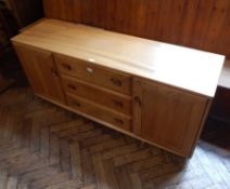 Ercol elm sideboard having three central drawers flanked by pair cupboards