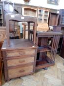 A revolving bookcase with open shelves and slatted sides, on castors,