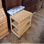 A stained open-fronted library bookcase and a pine tea trolley