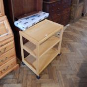 A stained open-fronted library bookcase and a pine tea trolley