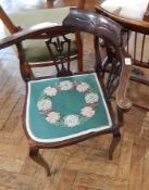 An Edwardian mahogany corner chair with needlework seat,