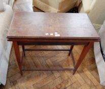 Early 20th century mahogany foldover swivel-top tea table on square tapering legs,