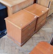 A pair of Stag furniture bedside cupboards with sliding shelf and two short drawers,
