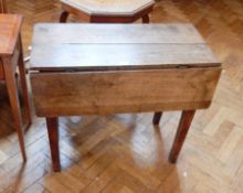 An old mahogany drop-flap dining table on square tapering legs,